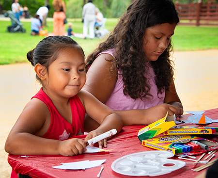 Two girls creating crafts at Rancho Los Alamitos